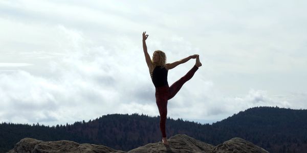 A younfg woman doing yoga outside.  Perfect motivation!